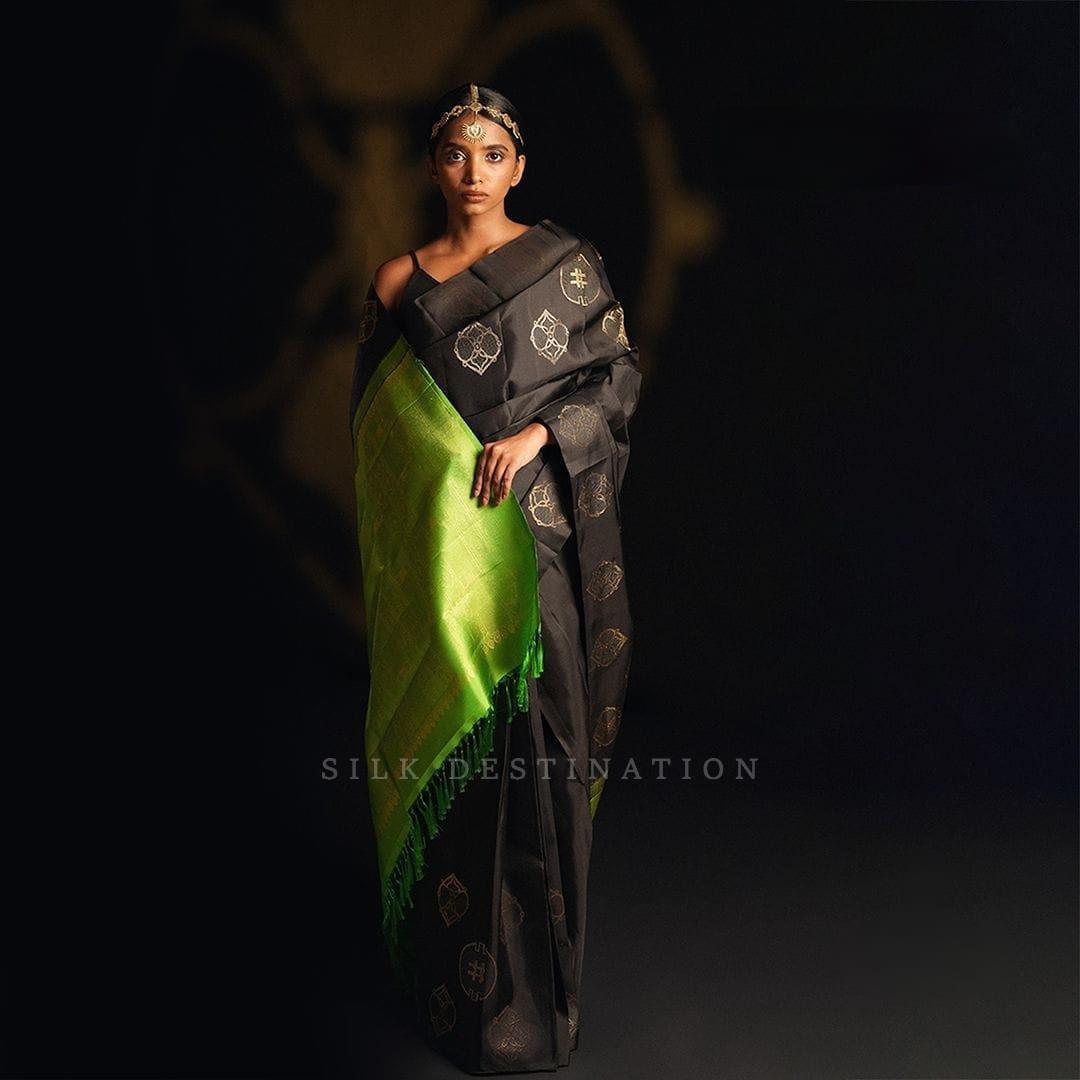 The black and green color of saree.