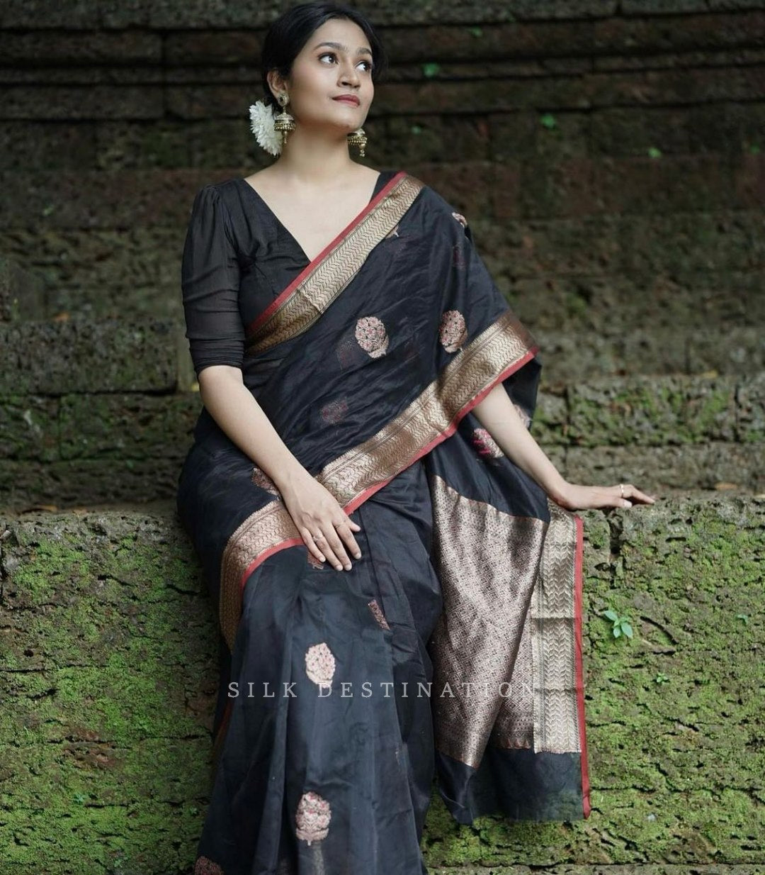 Black saree with flower design and gold red border Pallu