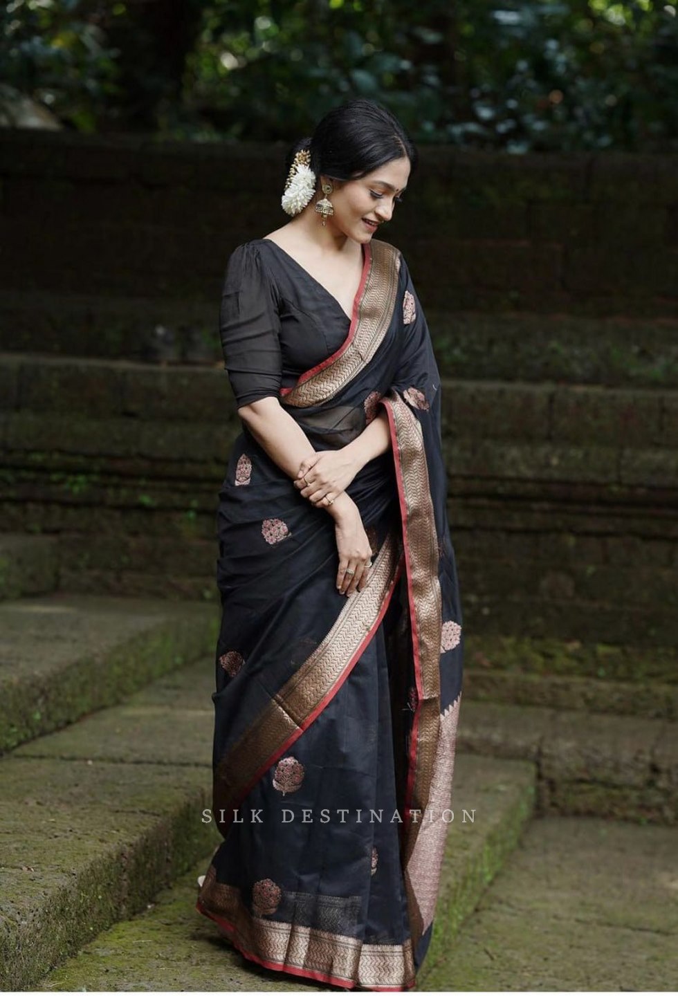 Black saree with flower design and gold red border Pallu